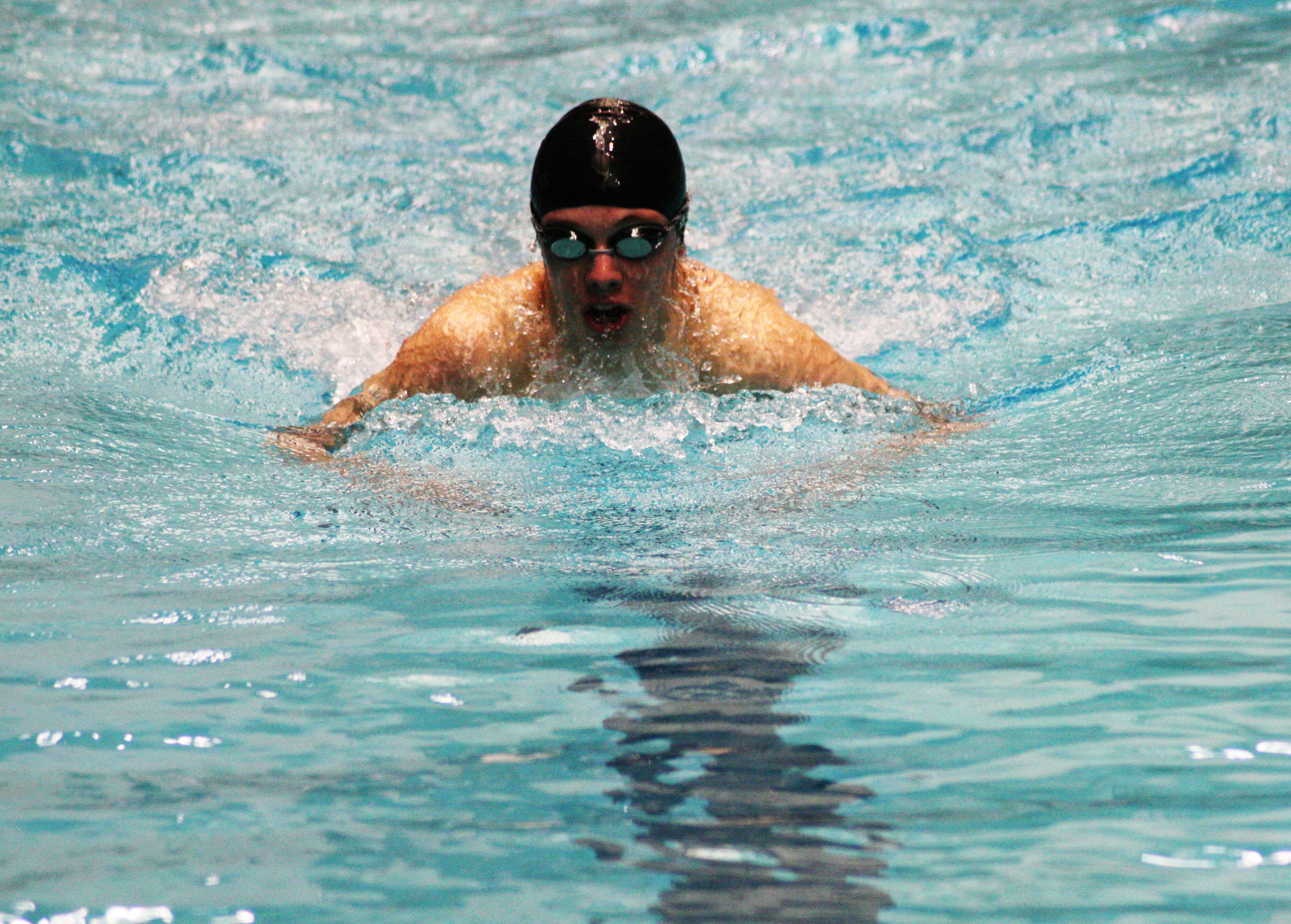 Kasey Calwell makes waves during the breaststroke portion of his 200 individual medley championship race.