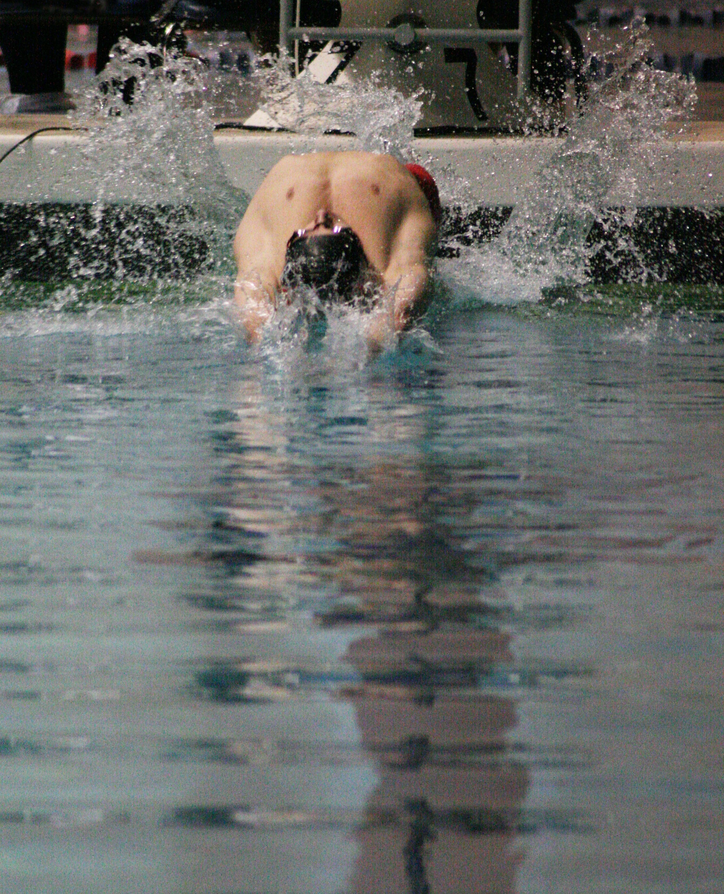 Lucas Ulmer disappears into the water at the start of the 100 backstroke.