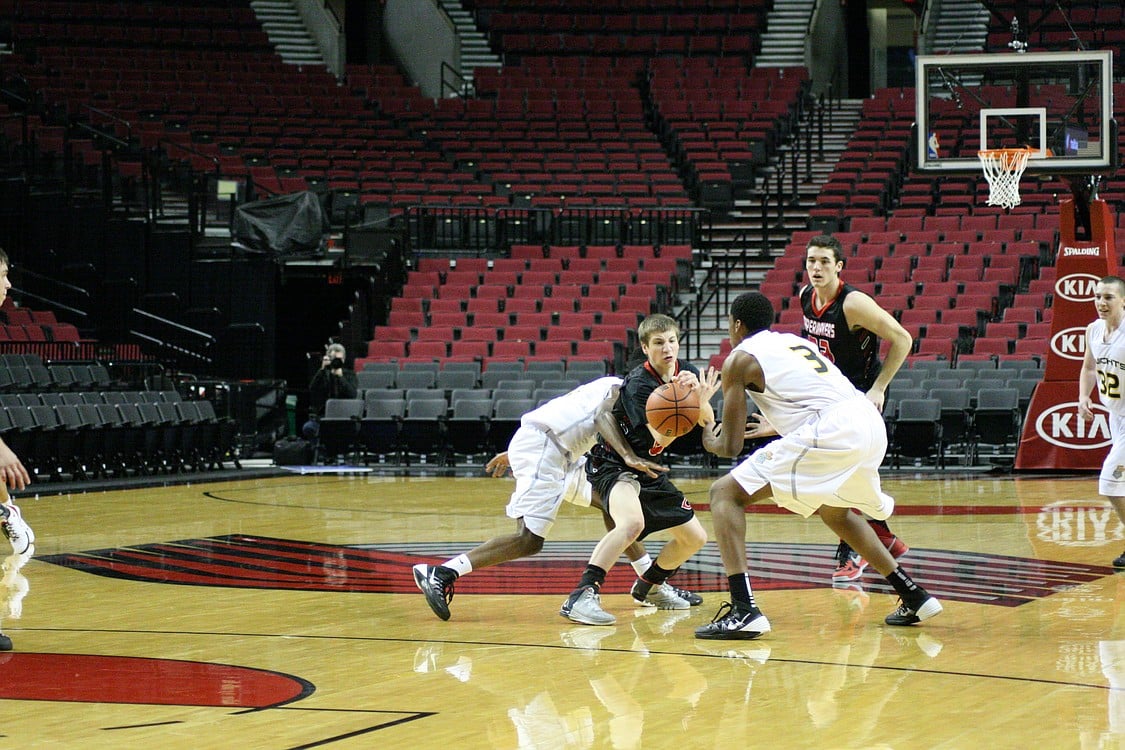 Jake Hansel fights for possession of the basketball.