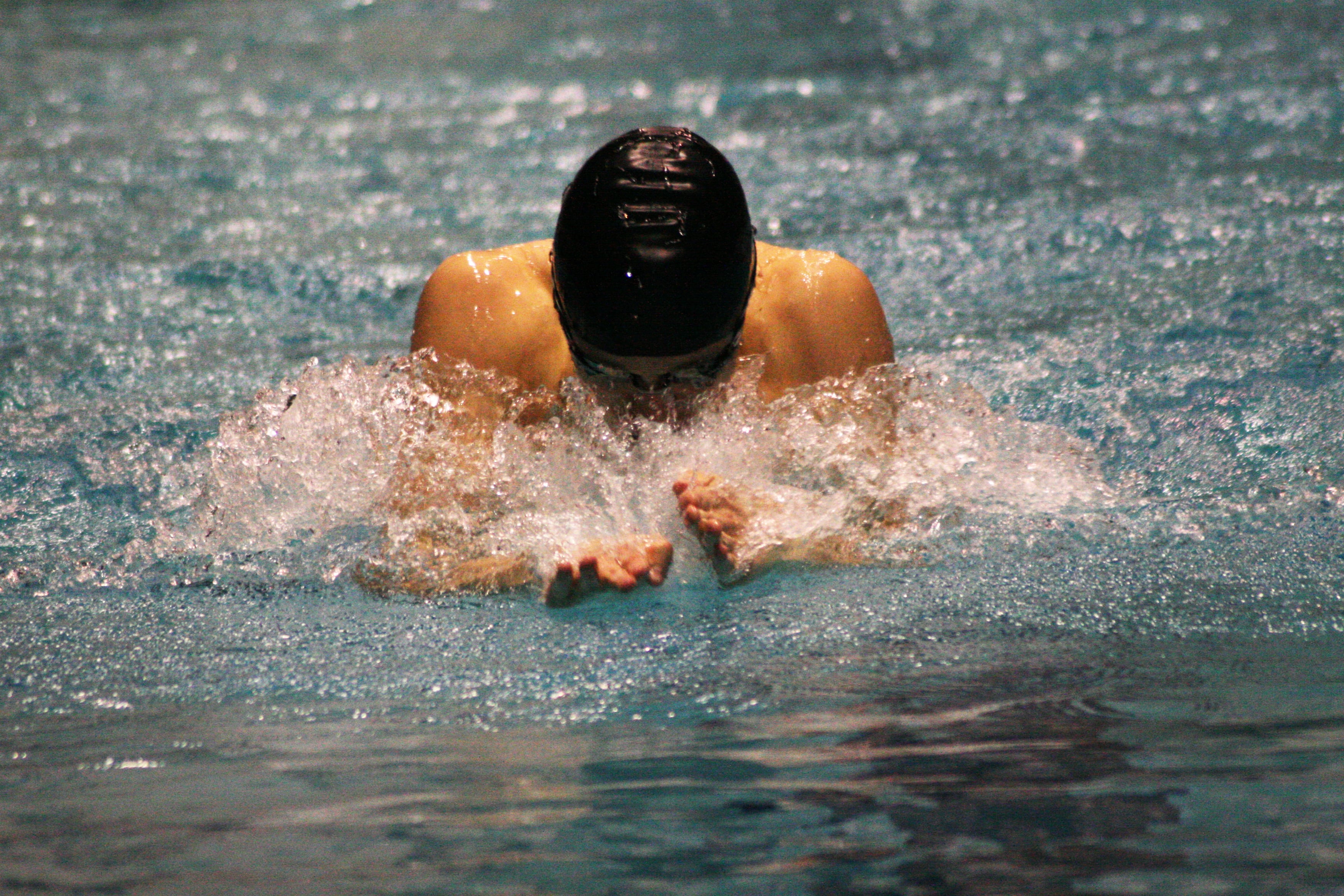 Kasey Calwell makes waterworks during the 100 breaststroke state championship race.