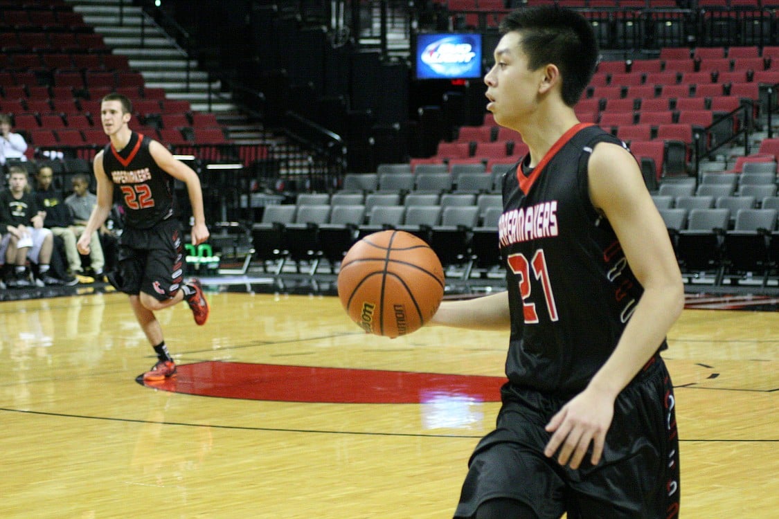 Brandon Nguyen brings the ball down the floor.