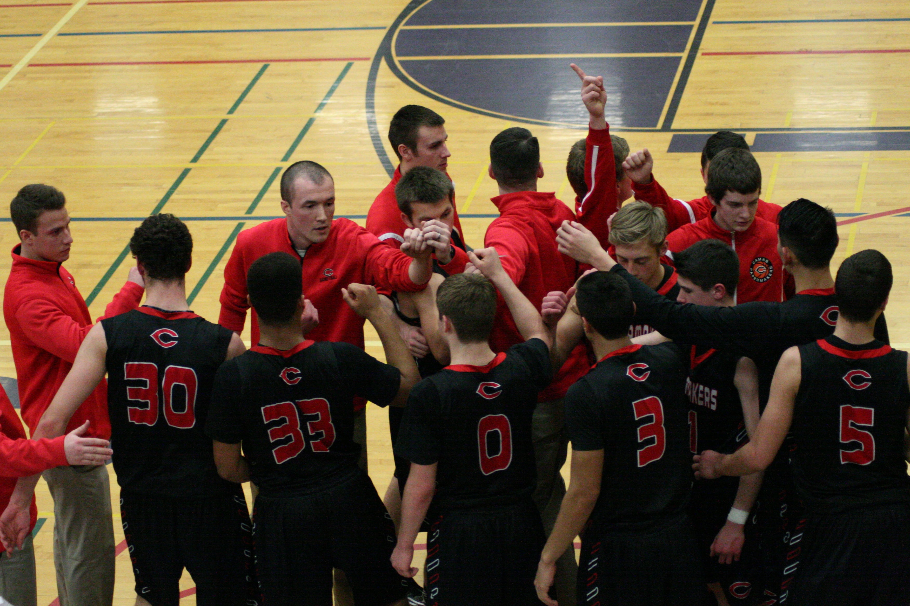 The Camas boys basketball players and coaches band together for one final push in the fourth quarter.