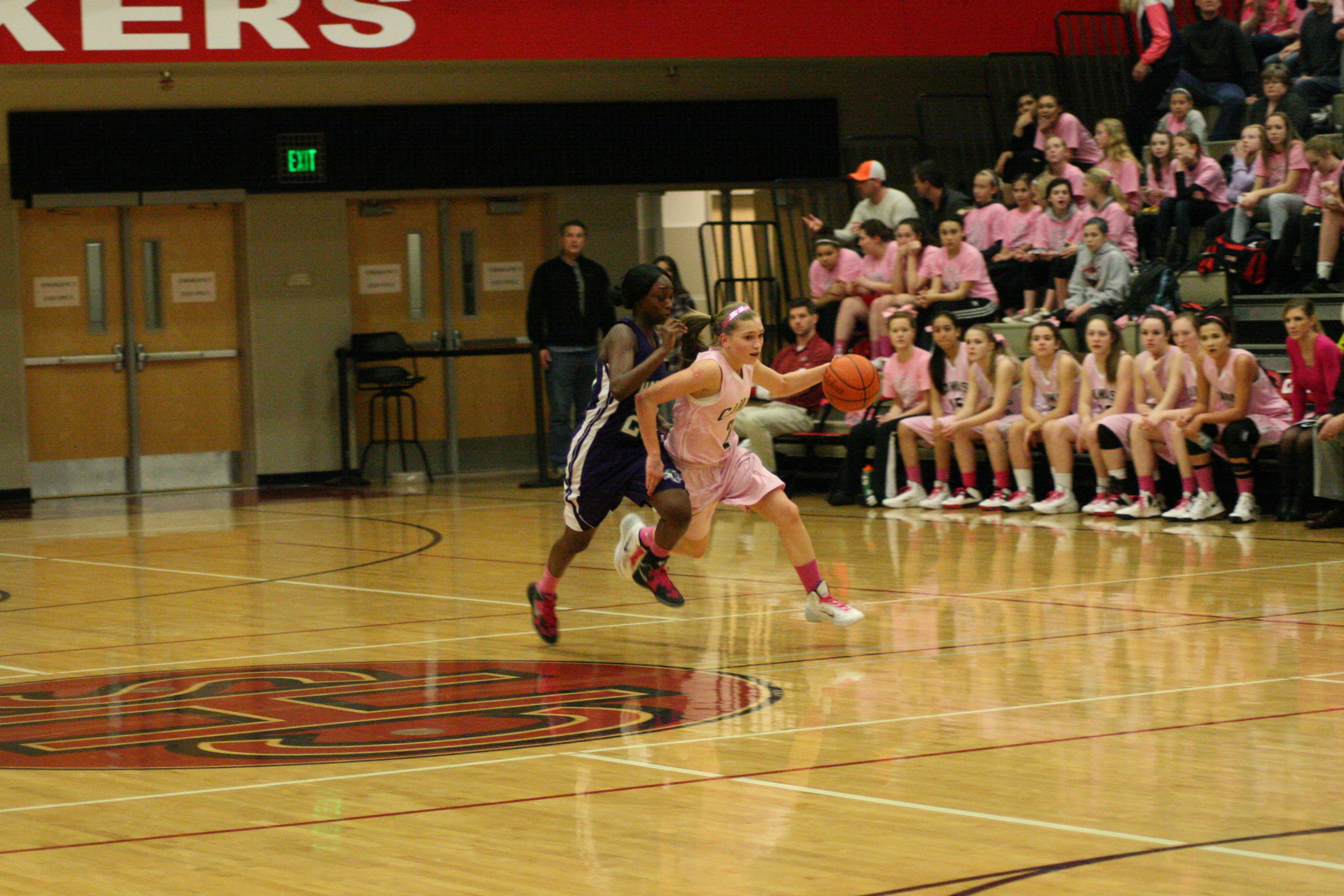 Camas freshman Meghan Finley glides by a Heritage girls basketball player.