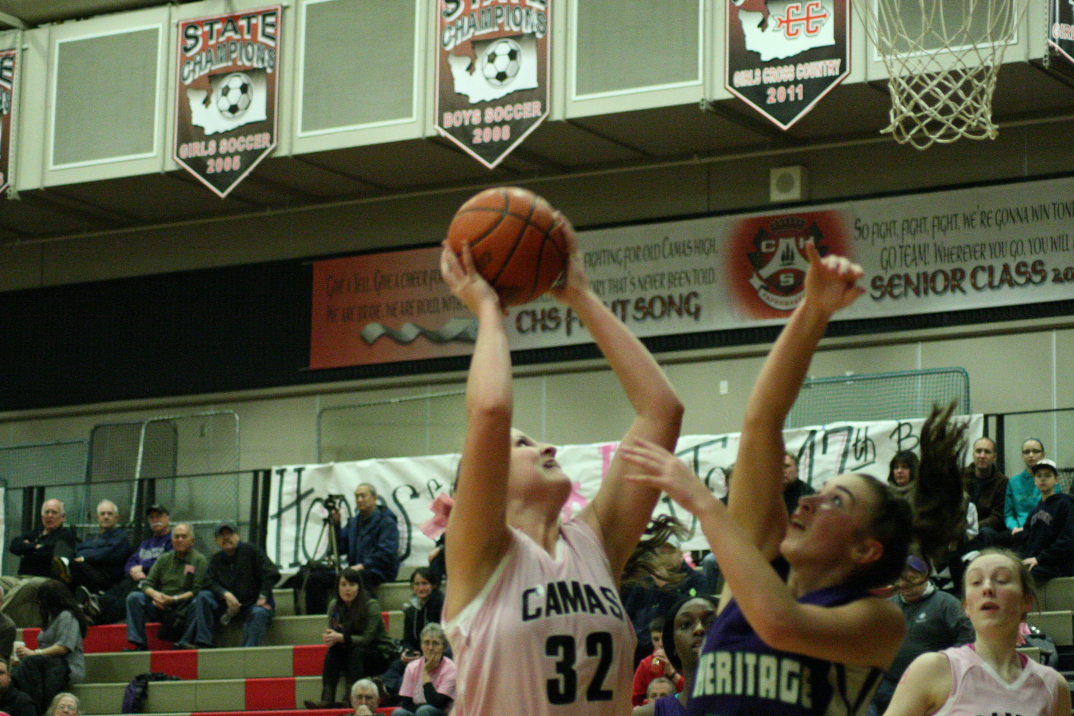 Camas junior Nikki Corbett shots over a Heritage girls basketball player.