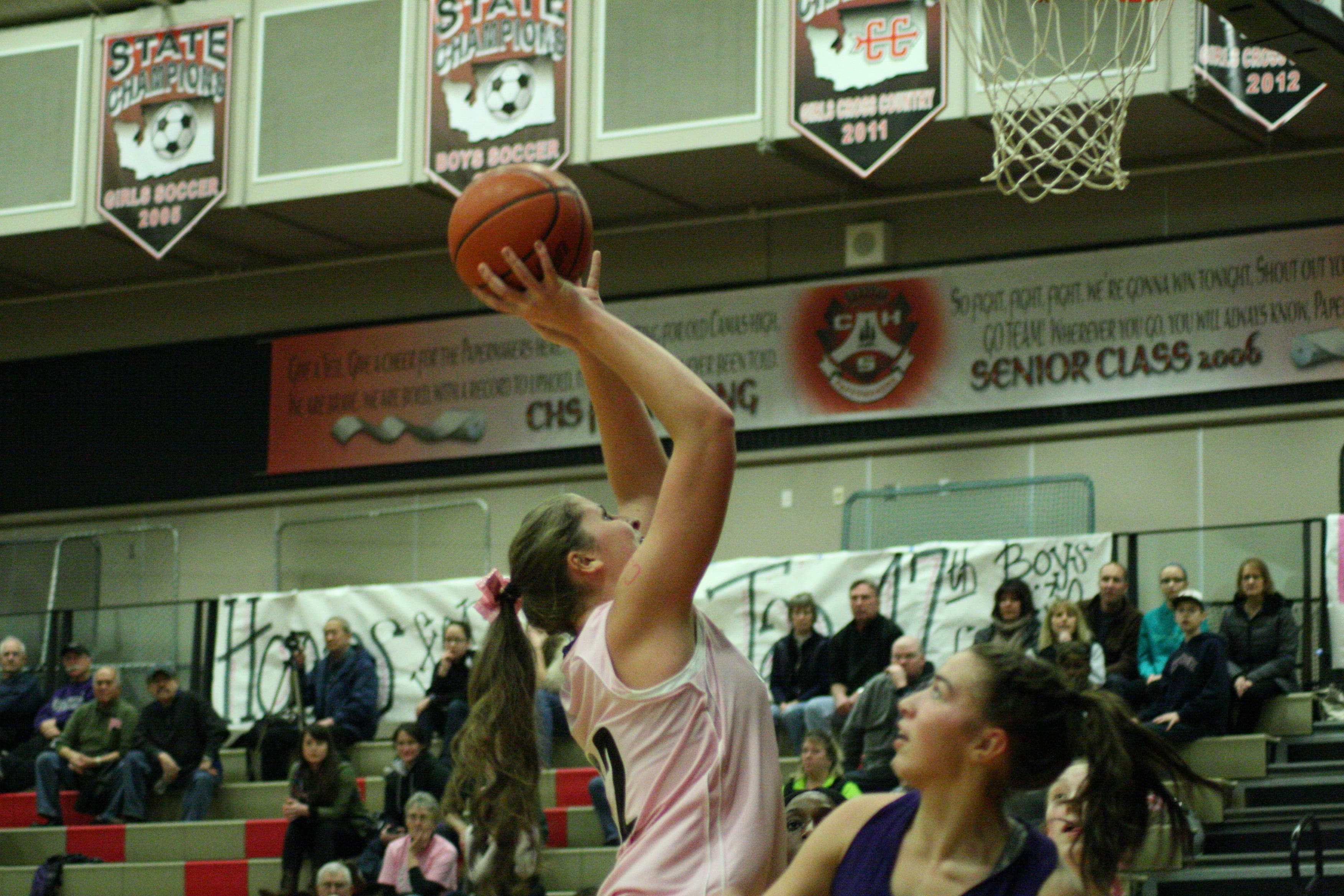 Camas junior Nikki Corbett shots over a Heritage girls basketball player.