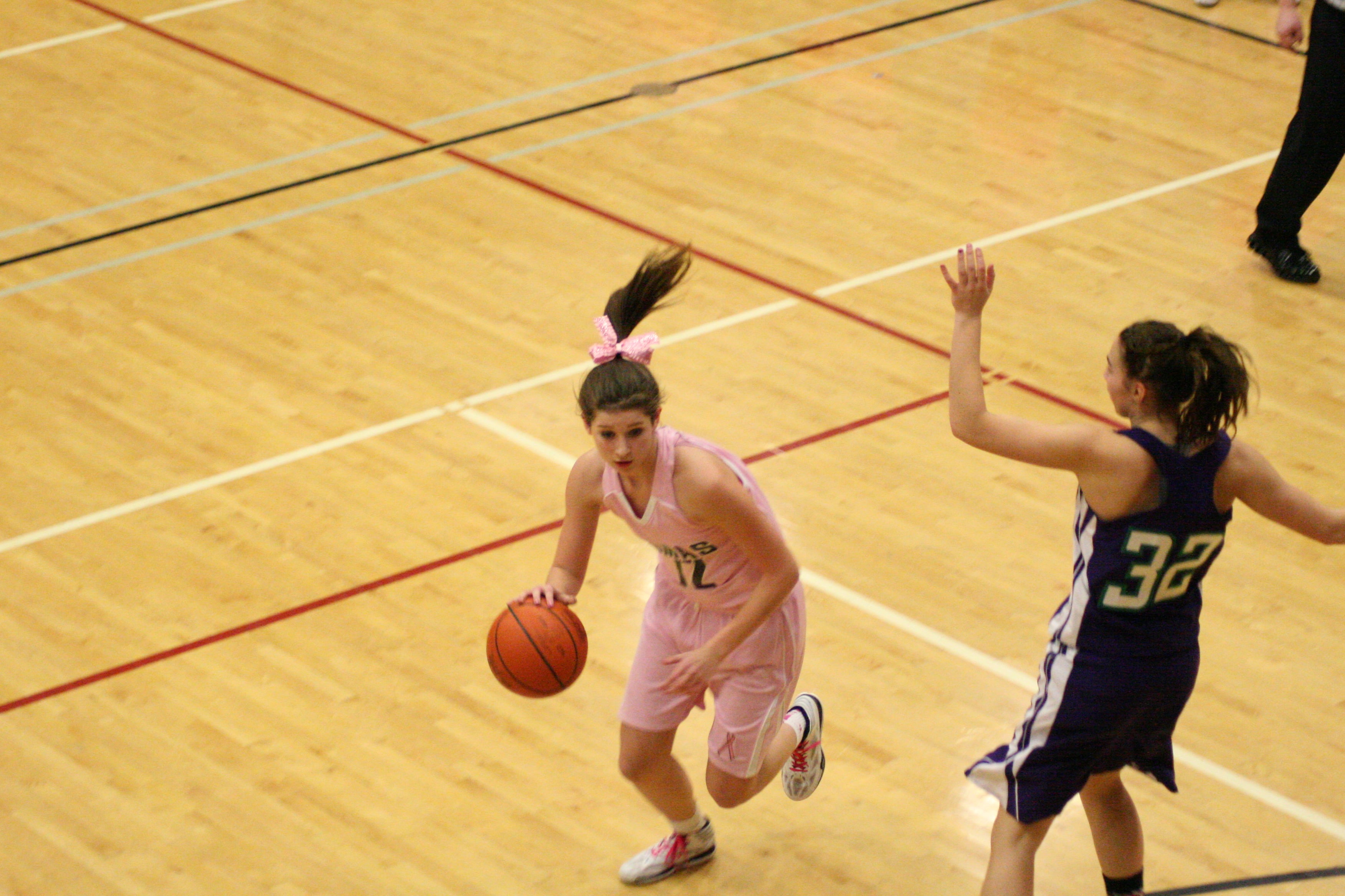 Camas sophomore Mia Hunt dribbles around a Heritage defender.