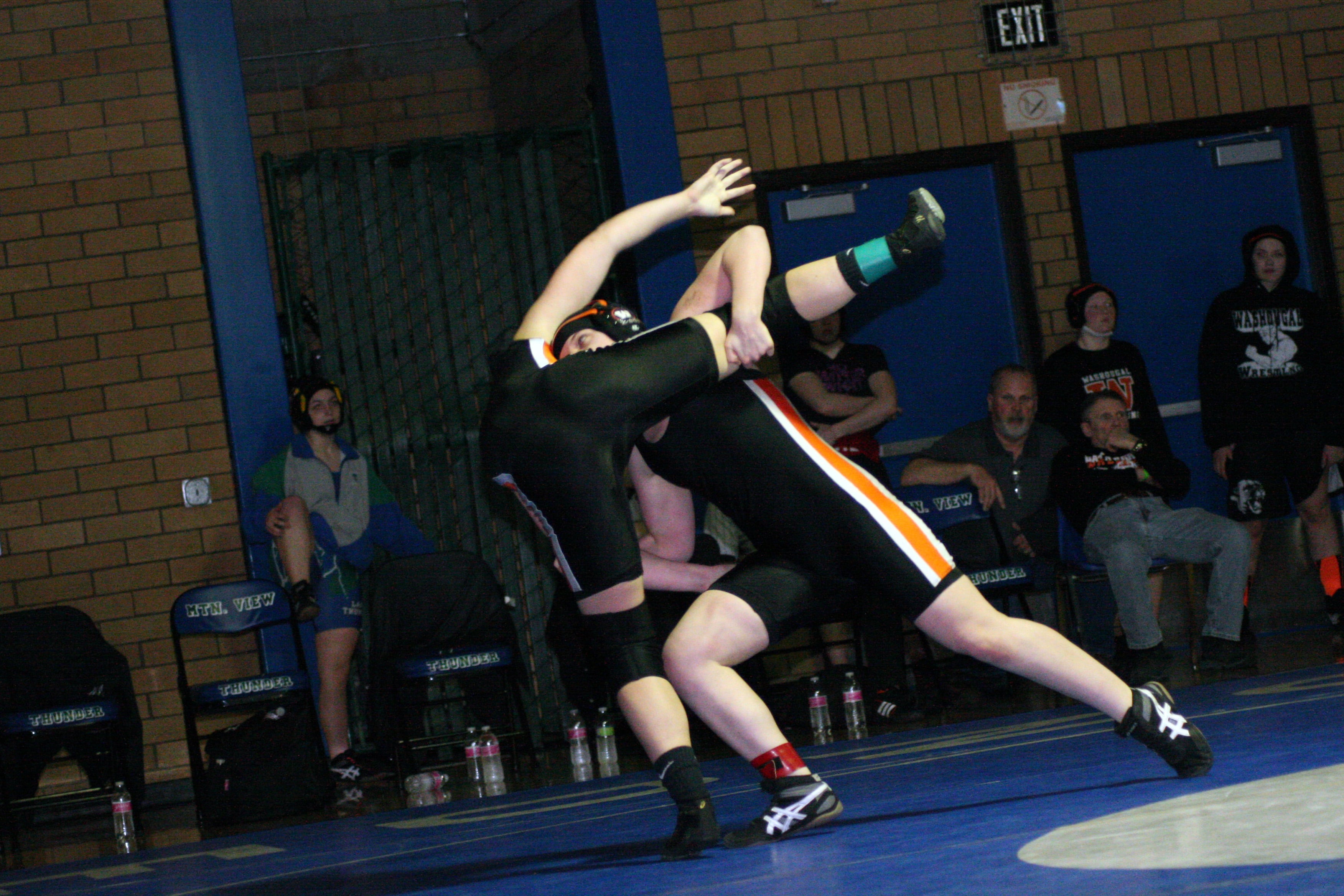 Erin Locke lifts Washougal teammate Morgan Ratcliff off the mat.