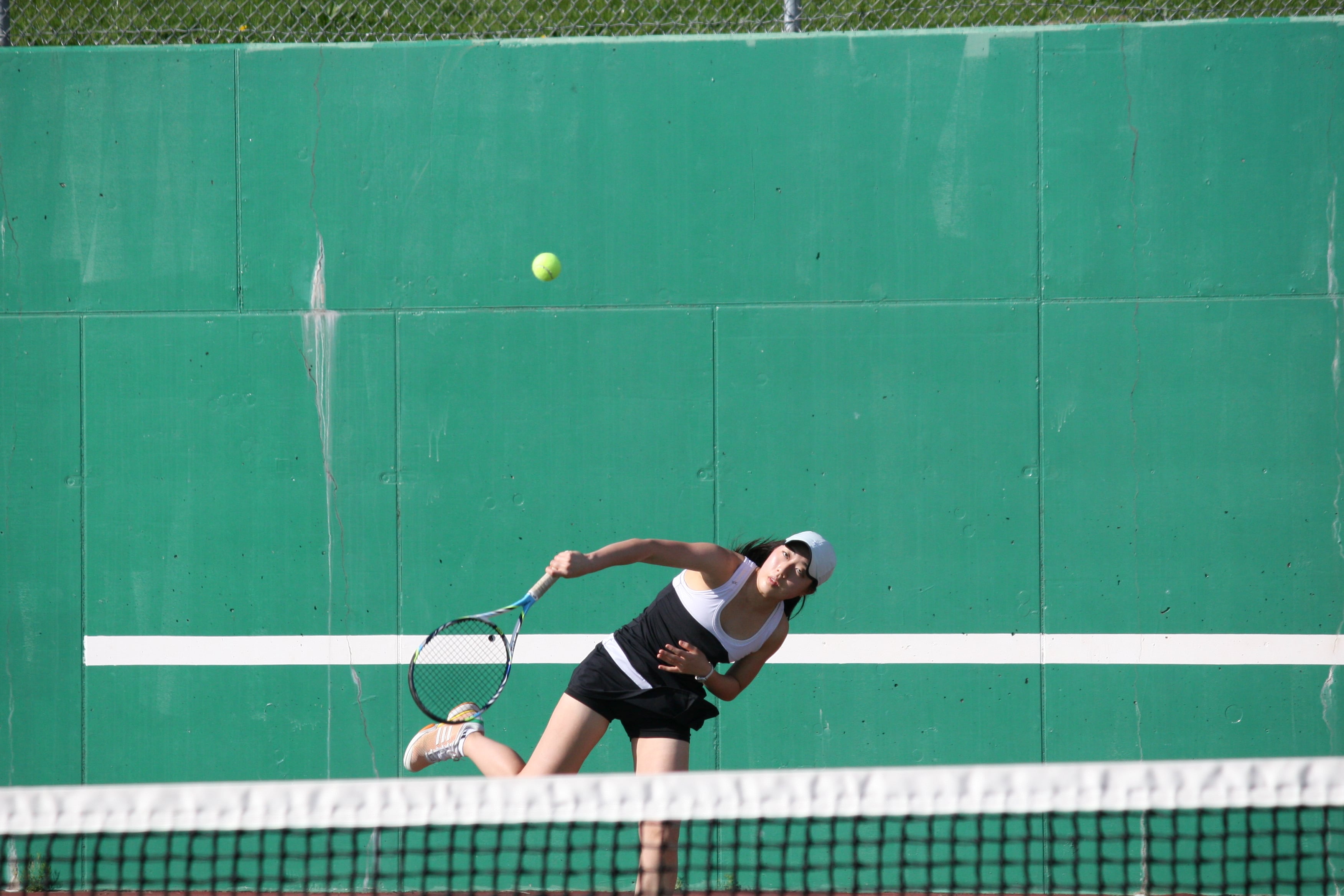 Esther Kwon hits the tennis ball at the right angle for a point.