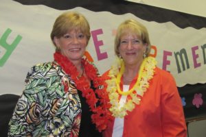 Longtime administrators Tanis Knight and Ina Evers-Martin celebrate at a Hawaiian themed party held in their honor. The two have worked for the Camas School District for a combined total of 52 years.
