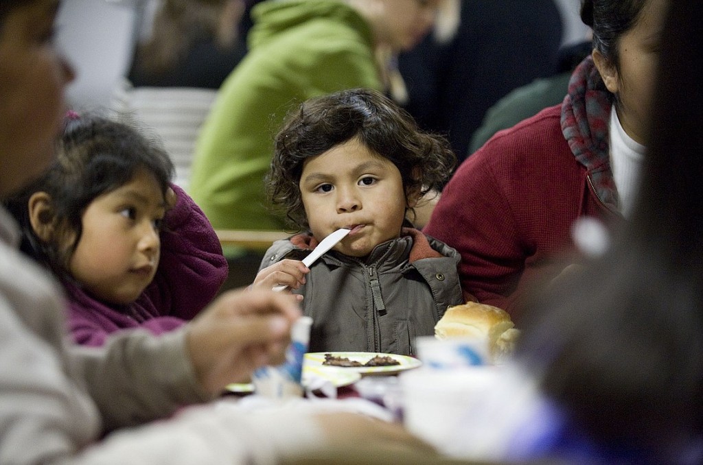 Photos by STEVEN LANE/The Columbian
Victoria Gomez-Bedolla, 5, left, and Melvin Gomez-Bedolla, 4, of Vancouver tuck into a Thanksgiving dinner with their family at the Vancouver Eagles Lodge
on Thursday. "These kids like it too much," smiled their father, glad of a holiday meal after some tough days in the landscaping construction business.