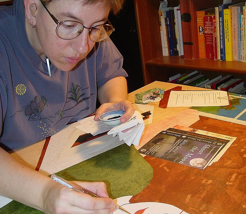 Contributed photo
Artist Sue Clancy works on a commissioned portrait of New York Times best-selling author Billie Letts. Here, she focuses on ink and acrylic detailing, after the cut paper pieces have been glued on and have dried.