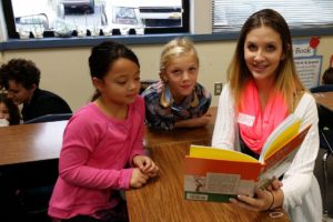 Gause Elementary School students Jayda Peterson and Avery Price read with Hana Nekvapil, a student in the WHS child development class. The students were required to bring an age-appropriate book for the "literacy field trip," to read with second-graders.