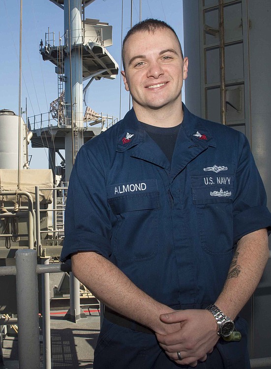 Cryptologic Technician (Technical) 1st Class Aaron Almond poses for a photo on the signal bridge of the USS Boxer (LHD 4). Boxer is the flagship for the Boxer Amphibious Ready Group and, with the embarked 13th Marine Expeditionary Unit, is deployed in support of maritime security operations and theater security cooperation efforts in the U.S. 5th Fleet area of responsibility.