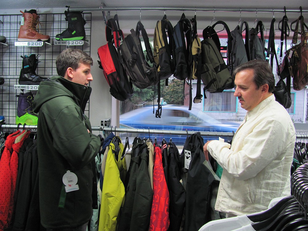 Customers try on winter apparel at Limitless recently. The Washougal outdoor water and snow sports store has built a niche in the area and will celebrate its three years in business this June.