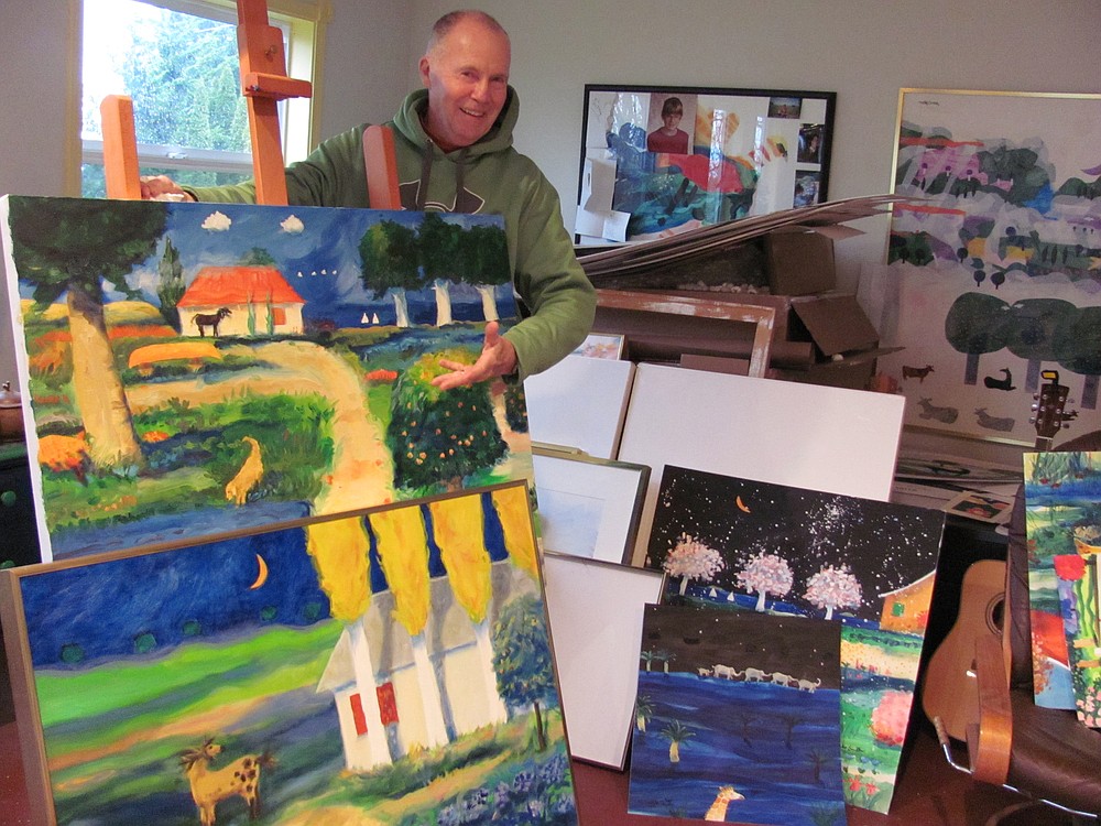 Mike Smith is represented by several galleries, including one in Hilton Head, S.C. Here, he poses with two pastels he is sending to the gallery. In the background are works in progress and a guitar from his Army days.   Horses feature prominently in his work. "Horses embody everything that is cool about the earth," Smith said.