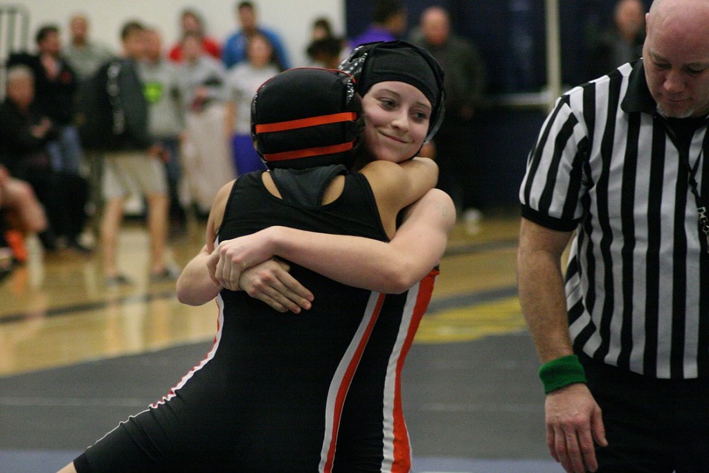Clark County champion Jessica Eakins gives teammate Yaneli Martinez a big bear hug after their 100-pound championship match. The Washougal girls captured another Clark County team title. See the photo gallery at www.camaspostrecord.com.