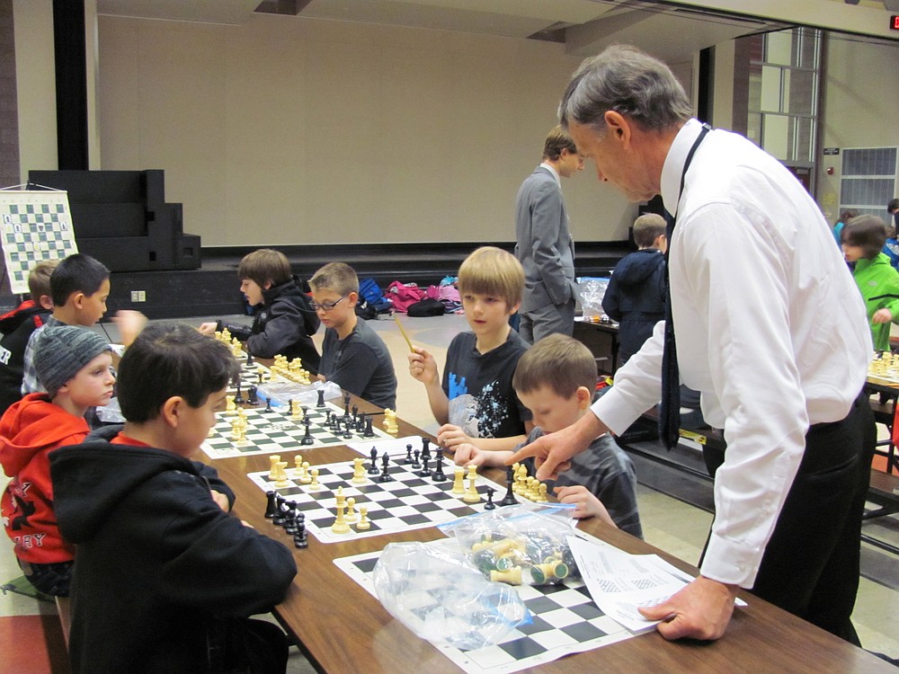 Alan Svehaug gives pointers during a recent chess practice. Unlike other sports, coaches are not allowed to talk to players during actual games, which requires that the participants have a thorough understanding of the game and their strategy.