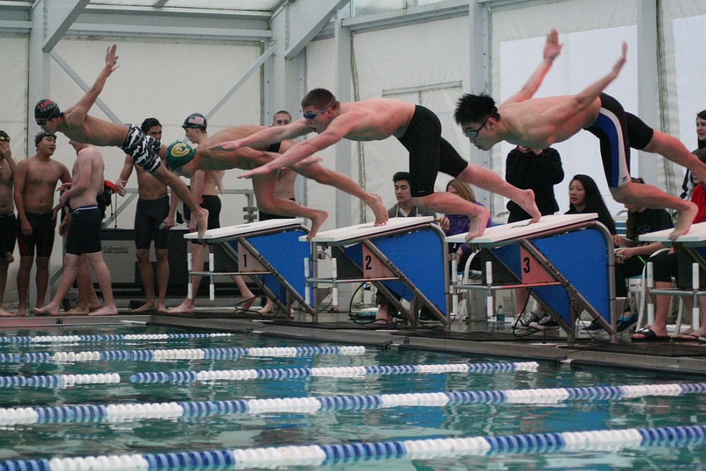 Camas High School seniors Trent Harimoto and Jake Yraceburu dive into the swimming pool Wednesday, at the Grass Valley Aquatics Center. Camas defeated Evergreen, Heritage, Mountain View and Union to become champions of the 4A Greater St. Helens League.