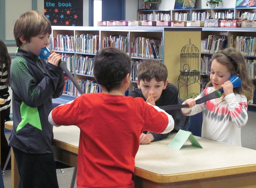 Communication was the topic of Wednesday's Mad Science class at the Gause Elementary School library. Here, students use funnels, connected with nylon, to "talk" to each other.