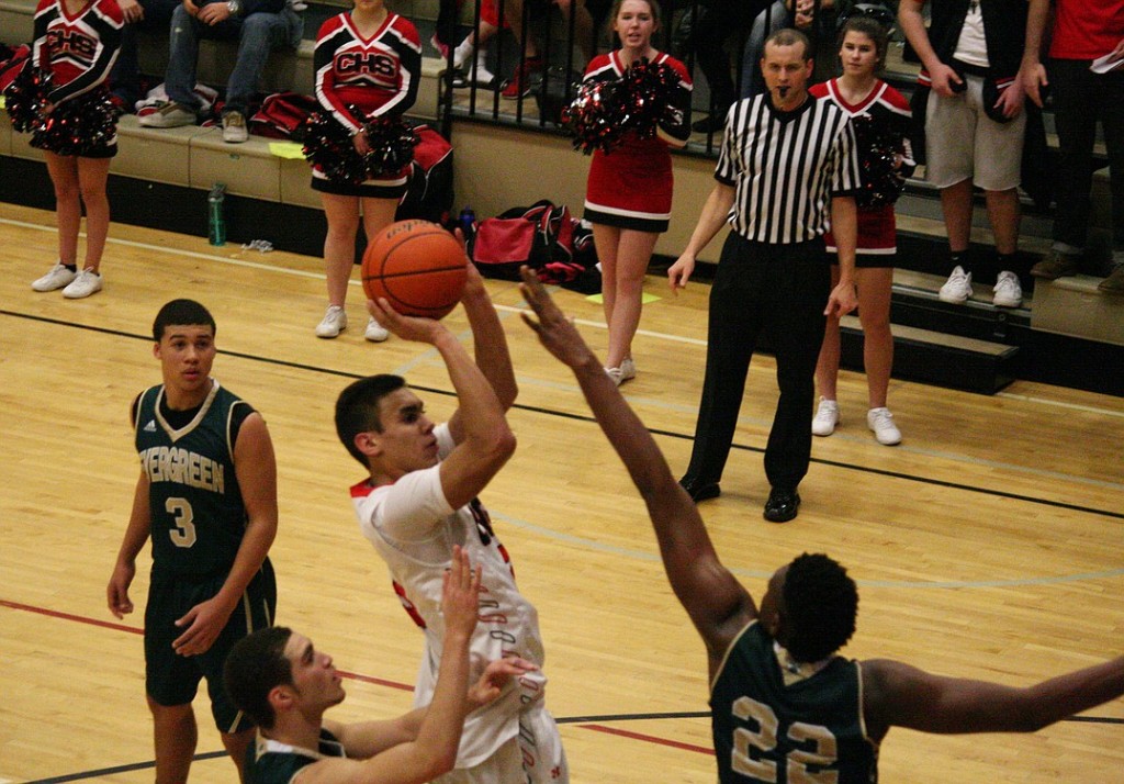 Andre De Los Rios rises above Robert Franks and scores a basket for the Papermakers. The Camas boys defeated Evergreen 62-49 Friday, at Camas High School.