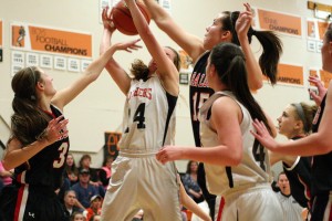 RaeAnn Allen (14) and Alyssa Blankenship battle two Lumberjills for the rebound Thursday, at Washougal High School. The Panthers defeated R.A. Long 63-53.