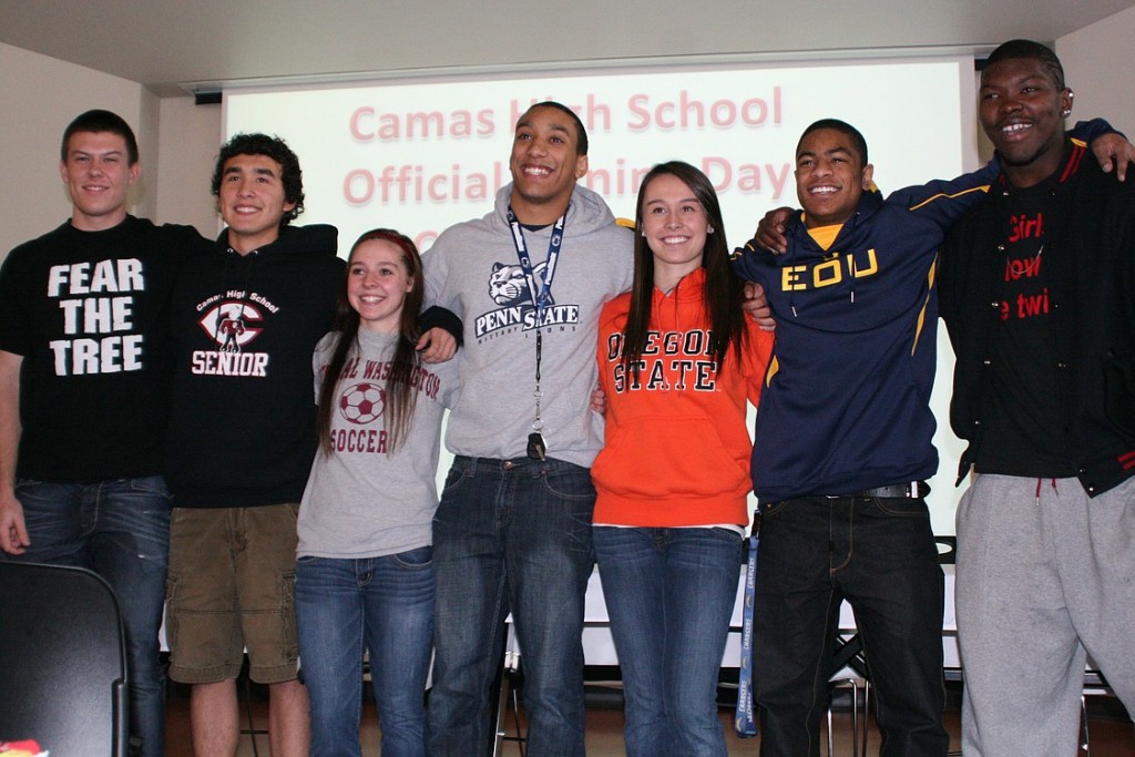 Camas High School seniors Austin Barr, Michael Koceja, Emily Ainsworth, Jonathan Warner, Olivia Lovell, John Payne and Kamari Brown (left to right) smile for the camera on National College Signing Day.