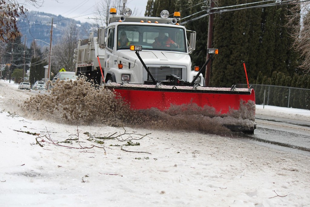 A City of Washougal snow plow cruises down 32nd Street on Sunday afternoon, scraping away snow and ice that had accumulated in the area on Friday and Saturday. Some freezing rain fell early Monday morning, but by mid-morning temperatures warmed above freezing and most of the main arterial roads in Camas and Washougal were simply wet. Side streets, however, remained covered with slushy snow, and some pockets of ice.