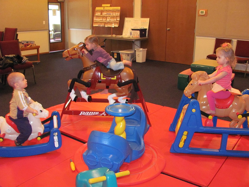 From left, Jake Carter, Camryn Corse and Ellison Corse ride the rocking horses.