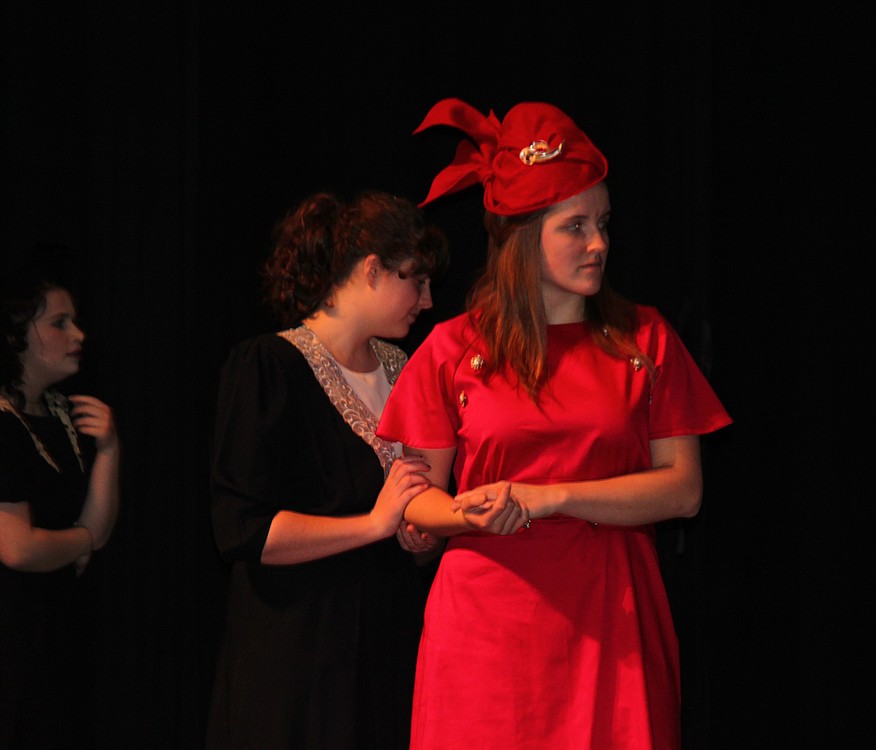 Lady Macbeth (Keira Stogin) listens to news from her husband while her attendant awaits her next move.