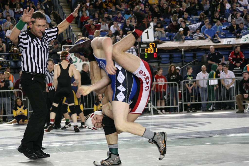 Camas senior Tyler Weiss attaches to Sedro Wolley's Boyce Johnson like a spider Friday, during the 3A state tournament at the Tacoma Dome. Weiss snagged third place.