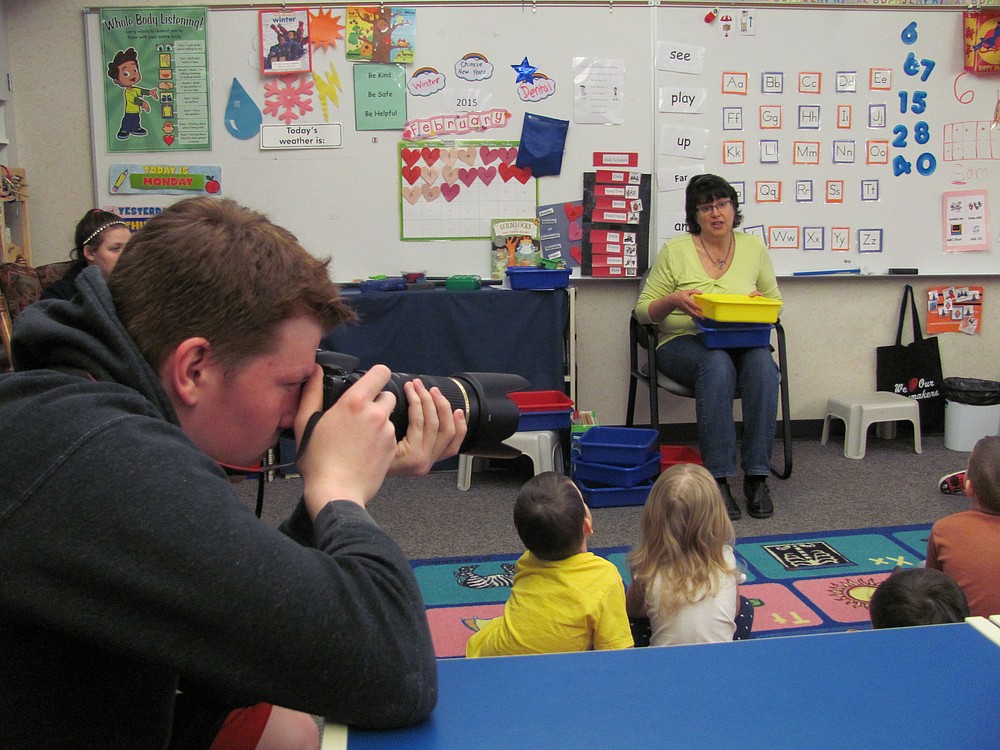 CHS student Donovan MacGowan photographs students at the Papermaker Preschool for their yearbook. MacGowan is designing and printing the yearbook for his senior project.