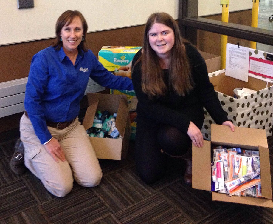 Elaine Hunt collected toiletry items as a part of her senior project volunteering for the Winter Hospitality Overflow program. Here, she stands with Missy Shepherd, who helped collect items from coworkers at her company for the effort.