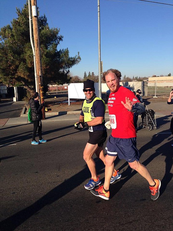 Kyle Robiduox (right) finished in third place in his division with the help of his guide Dan Streetman at the California International Marathon, in Sacramento. Robiduox is training for the Boston Marathon. His guides will be his sister-in-law Julie Kimmel, of Reston, Va., and brother Jayson Robiduox, of Camas.