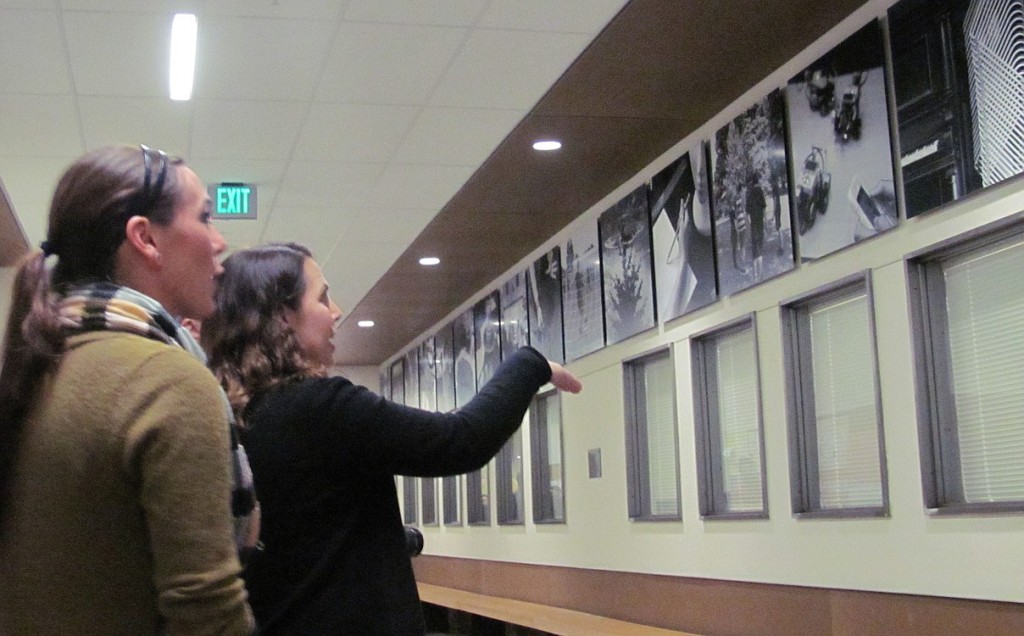 Hayes Freedom teachers Corrine Lorch (left) and Monica Winkley look at de Lory's 19 photos. These were captured in and around the school, and are now displayed in the main hallway.