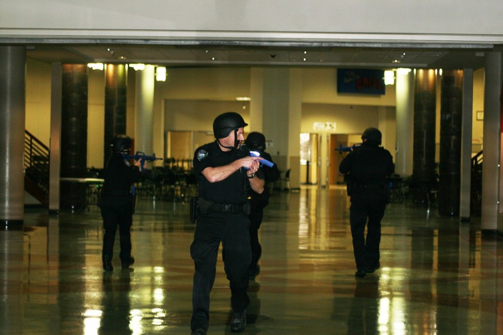 Camas police officers check CHS during a lockdown drill last Tuesday. They carried blue plastic gun replicas to add an element of realism. It is the first time the police have been involved in a lockdown drill at the school.
