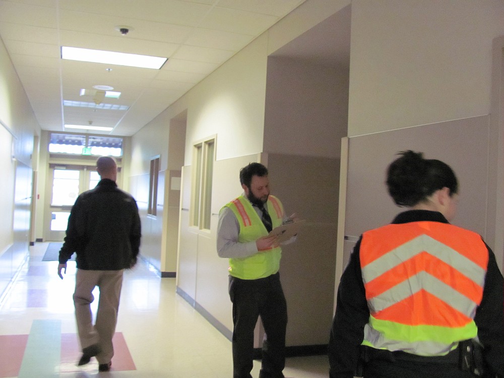 CHS dean of students Bryan Wilde (center), Camas police Det. Brent Mayhugh, and Capt. Shyla Nelson perform classroom checks during the drill.