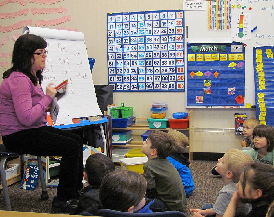 Grass Valley Elementary School kindergarten teacher Ellen Keller works on a reading and writing exercise with students. "We want them to read before they leave kindergarten, but with (Common Core) standards, now we expect them to write as well."