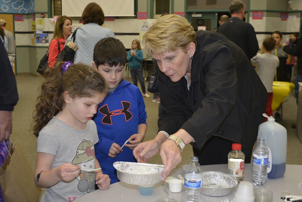 Amelia and Lincoln Connolly experiment with science while teacher Kam Lawrence lends a hand. 
Several teachers and classified staff volunteered their time that evening.