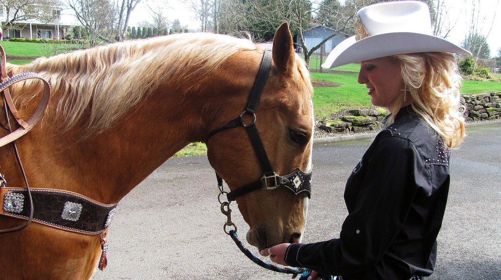 Amanda Knapp feeds grain to Carter. Knapp, 20, is the Miss Vancouver Rodeo Queen for 2014. The rodeo will be held July 2-5, at the Clark County Saddle Club. Before then, Knapp and Carter are participating in several parades.