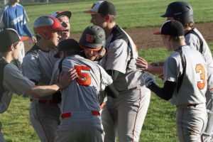Panthers roughhouse on the diamond after Brandon Casteel brought home the winning run in a 6-5 victory against La Center in eight innings Thursday, at Washougal High School.