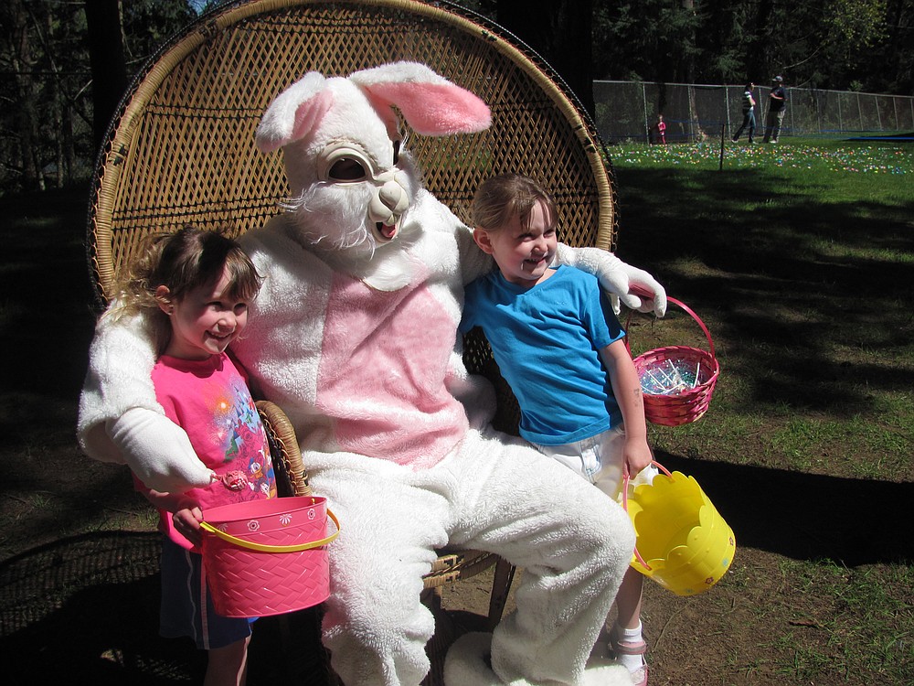 Children can pose for a photo with the Easter Bunny after the annual Washougal Eagles egg hunt.