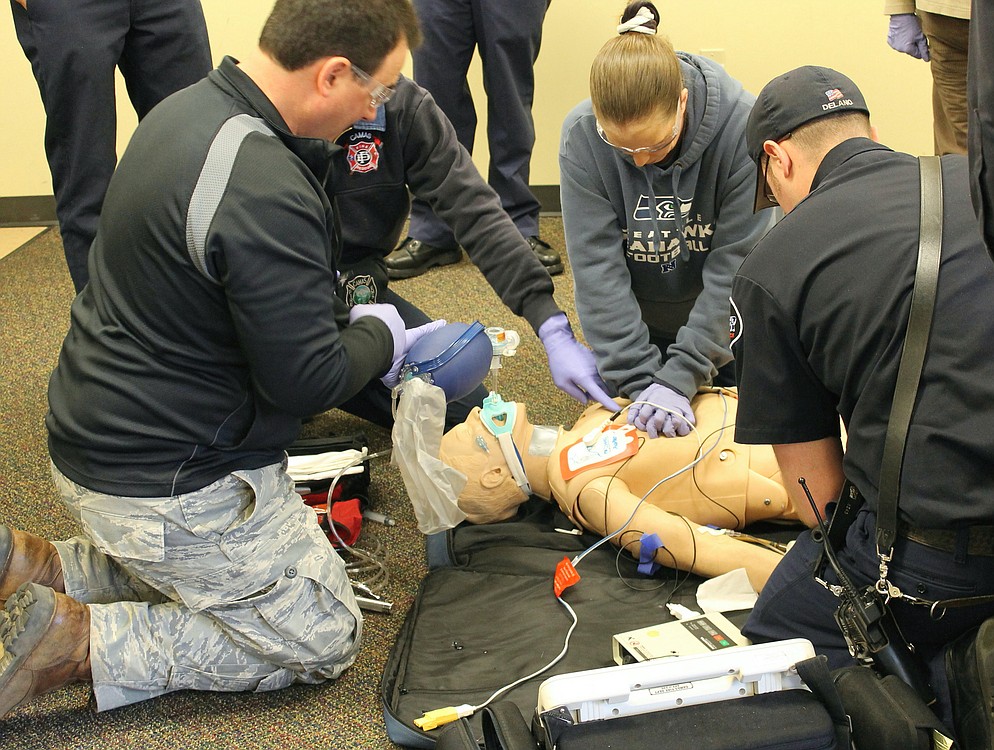 Citizen Academy participants work with ECFR firefighters and Camas Fire Department paramedics during a mock "Code 99."  Mike Milani breathes for the CPR mannequin while Sheila Plato performs CPR.  Camas Fire Captain/Paramedic Greg Weisser and ECFR Fire Fighter/IV Technician Brad Delano provided pointers and assisted in the resuscitation drill.