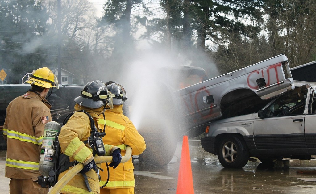 Photos courtesy of ECFR
Citizen Academy participants Martha Martin and Sheila Plato work with ECFR Intern Fire Fighter/EMT Reece Bonenfant to extinguish a fire in the cab of a pick-up truck.  The group learned how to handle charged fire hoses while safely approaching vehicle fires.  Exploding pressure cylinders in "low impact bumpers" can seriously injure emergency responders as firefighters approach vehicles at angles to avoid flying bumpers and rocketing cylinders.  The 1.75-inch fire hoses, used to extinguish vehicle fires, deliver 180 gallons of water per minute at a nozzle pressure of 100 psi.