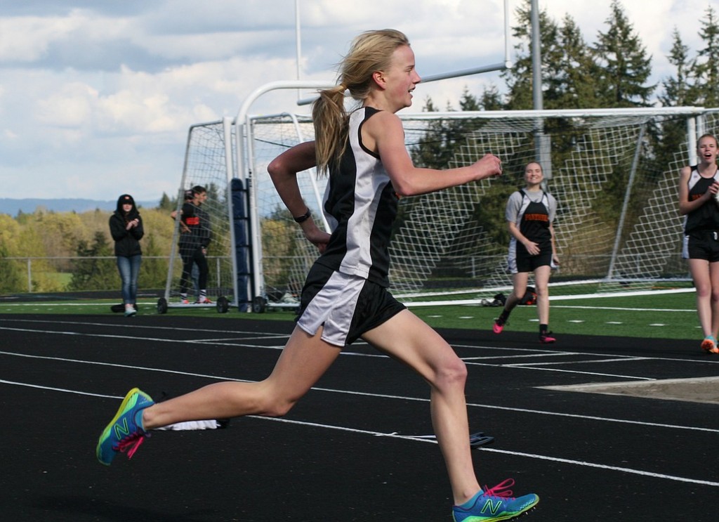 Courtney Owens kicks to the finish line for Washougal Thursday, at Ridgefield High School. The sophomore ran the school's third fastest girls mile time of 5:32.49.