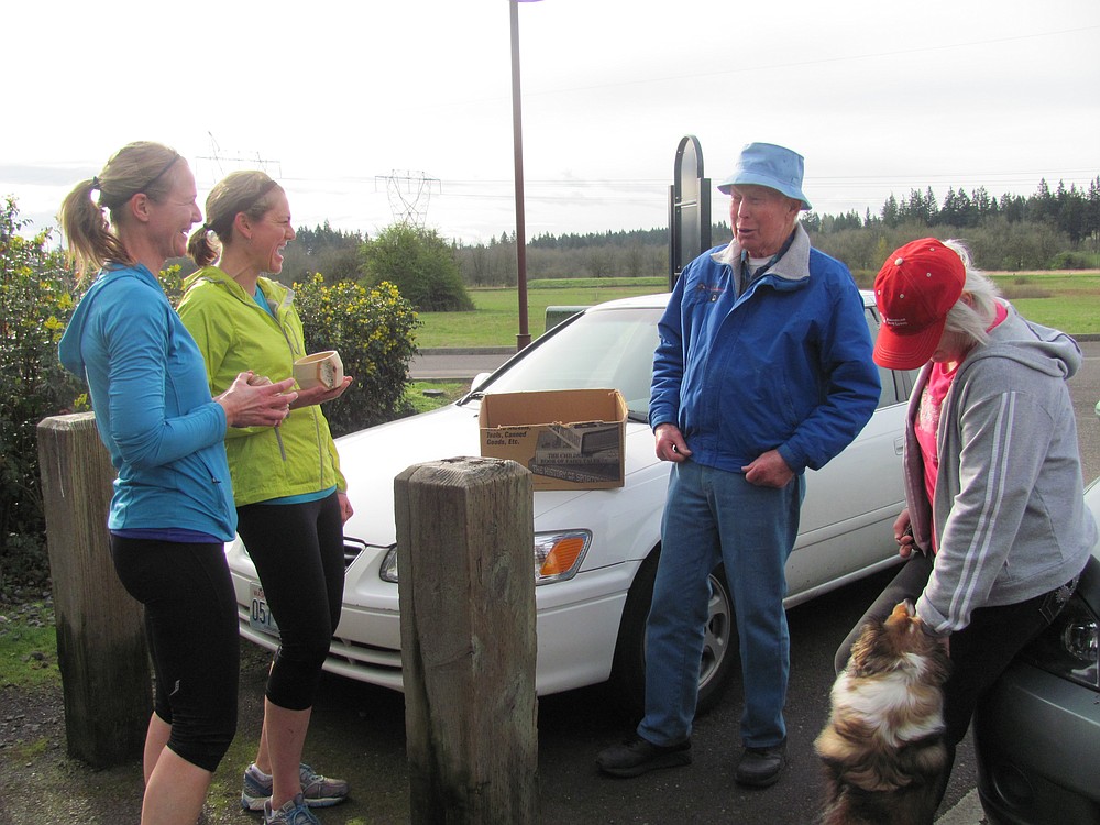 Larson chats with runners at Heritage Trail, while Hursh and Dixie look on. In addition to walking, he enjoys wood carving, and many trail users have been recipients of his creations.