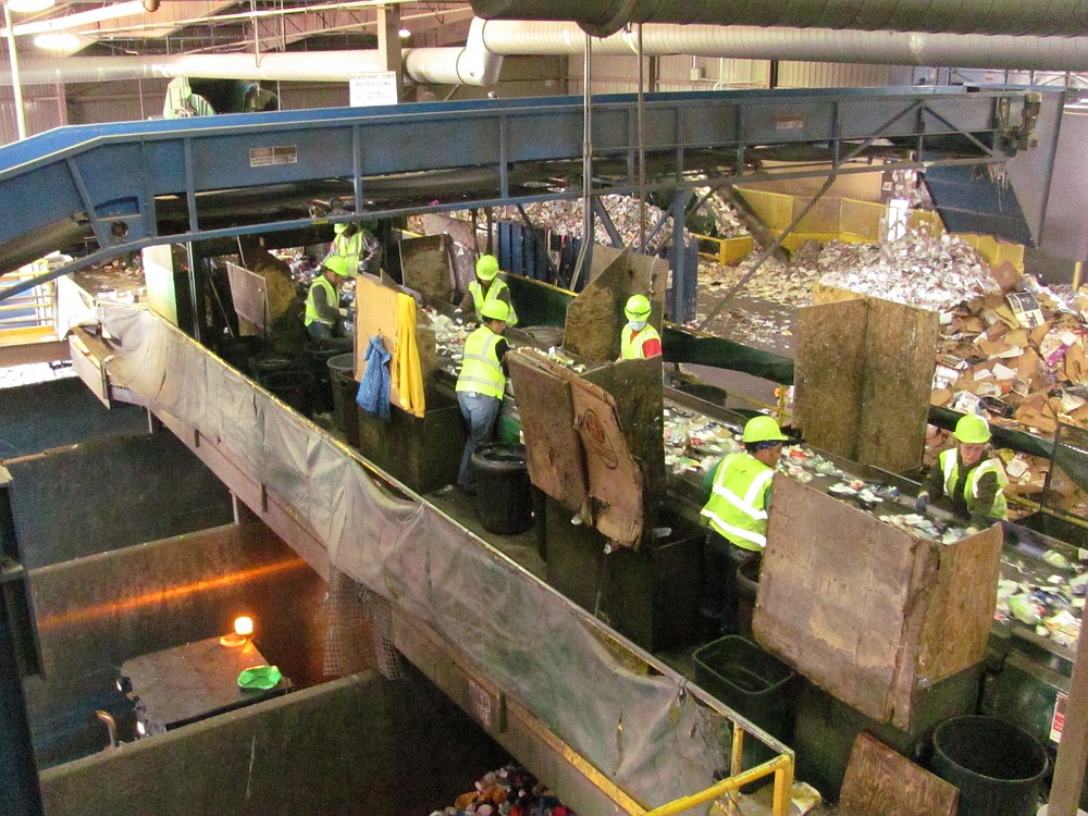 Employees sort through items at the recycling center at Waste Connections. Each one is responsible for a different commodity.