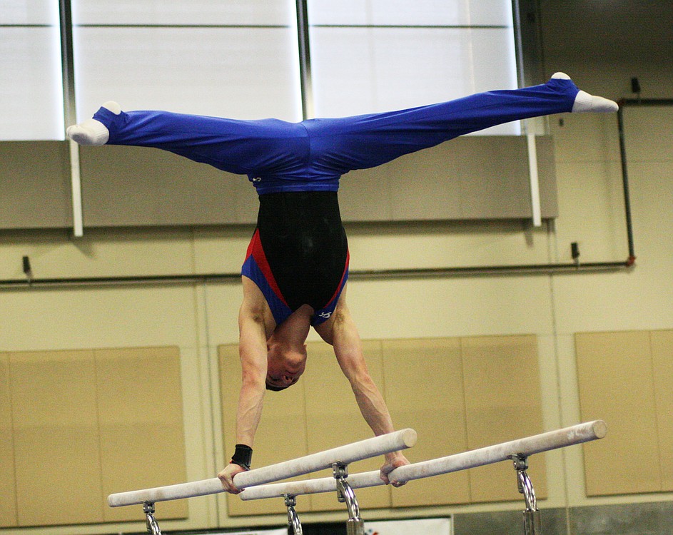 Ryan Dietzman balances on top of the parallel bars. The Camas gymnast earned second place on the vault, and third place on the high bar and the floor exercise. He also took sixth place in the all-around.