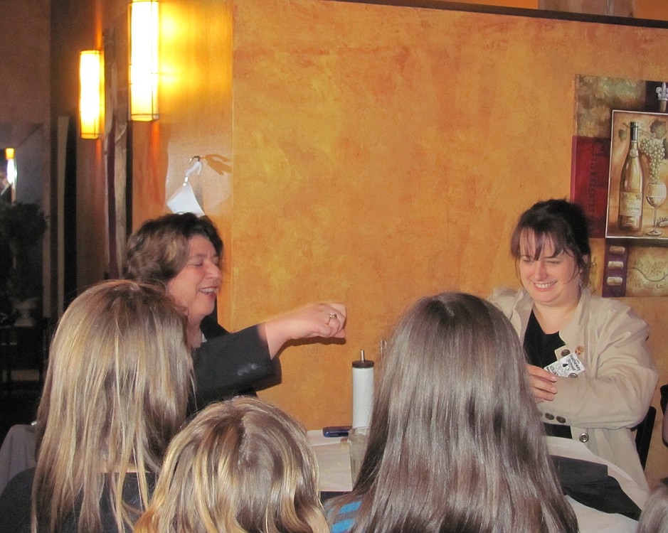 Linda Haines and Jocelyn Lindsay pretend to sample from each other's plates during the "bad manners," skit for several fifth-grade girls at Hathaway Elementary School. After the skit, they enjoyed a lunch with good manners as a part of the Young Women in Action program.