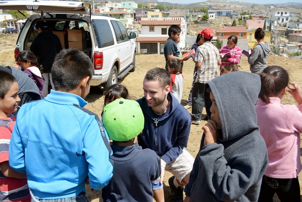 Recent CWU graduate James Heberling of Camas  interacts with children in a neighborhood in Baja, Mexico where he and other students, recent graduates and business people helped build a house for three orphaned siblings over spring break in March.
