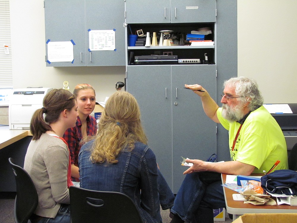 Ninth-grade students meet with Wright to discuss symposium projects. All Math, Science and Technology Magnet Program participants must complete a year-long research project. "He's very dedicated, and cares a lot about students success," said ninth-grader Anna Roche.